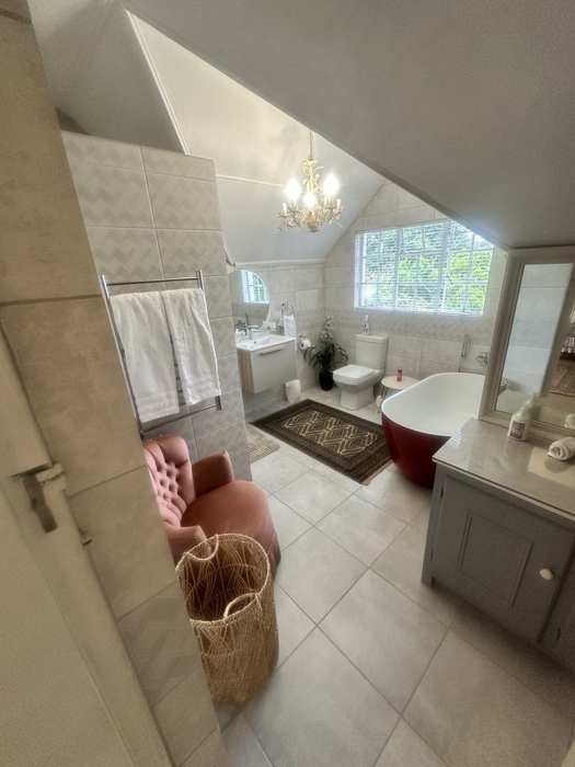 Shared bathroom with freestanding bath and seating