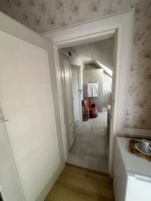 Shared bathroom entrance and seating area