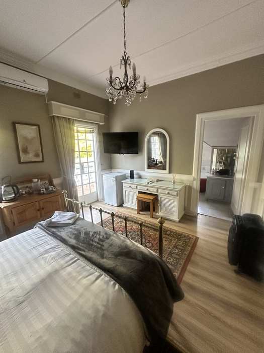 Bedroom 1 with French doors to its balcony