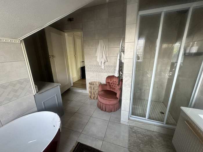 Shared bathroom shower and freestanding bath