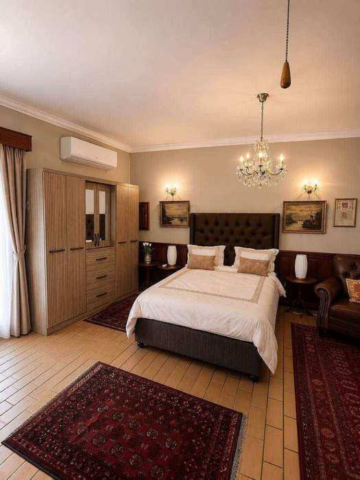 Wide view across the bed and lounge areas