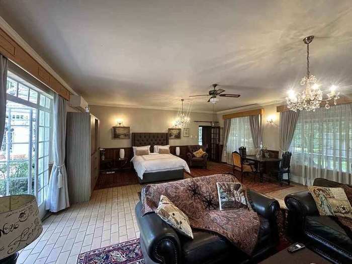 Full view across the suite toward the panoramic garden windows