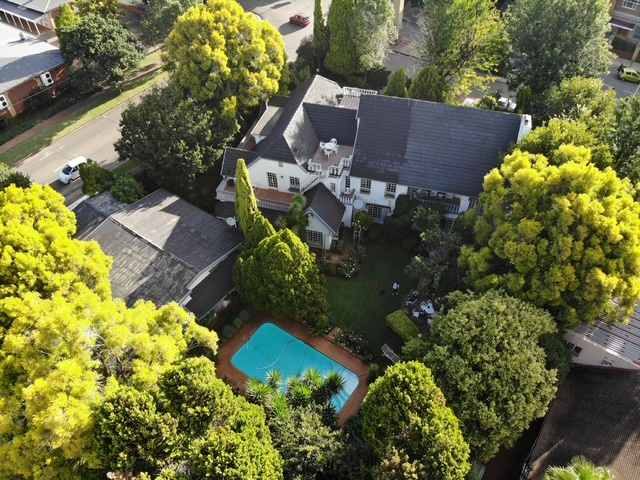 Aerial view of Garden Court, its garden and swimming pool