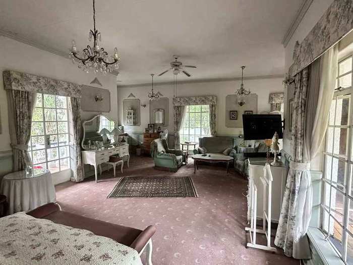 Private furnished balcony surrounded by mature trees